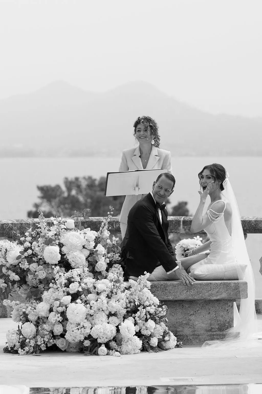 A black-and-white photograph of a couple during their ceremony led by Ximena
