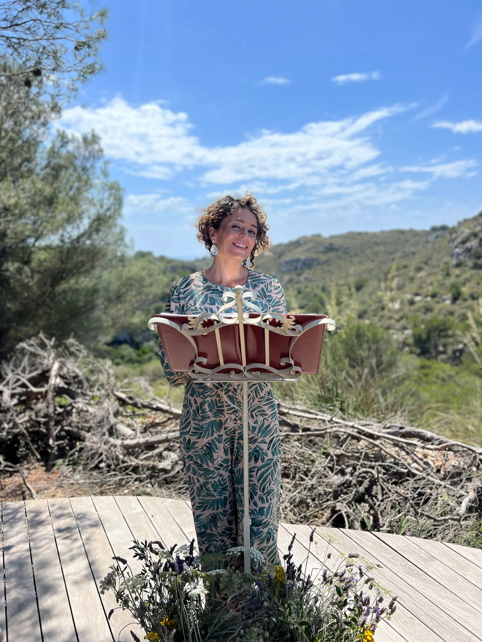Ximena holding her ceremony book in a sunny outdoor setting