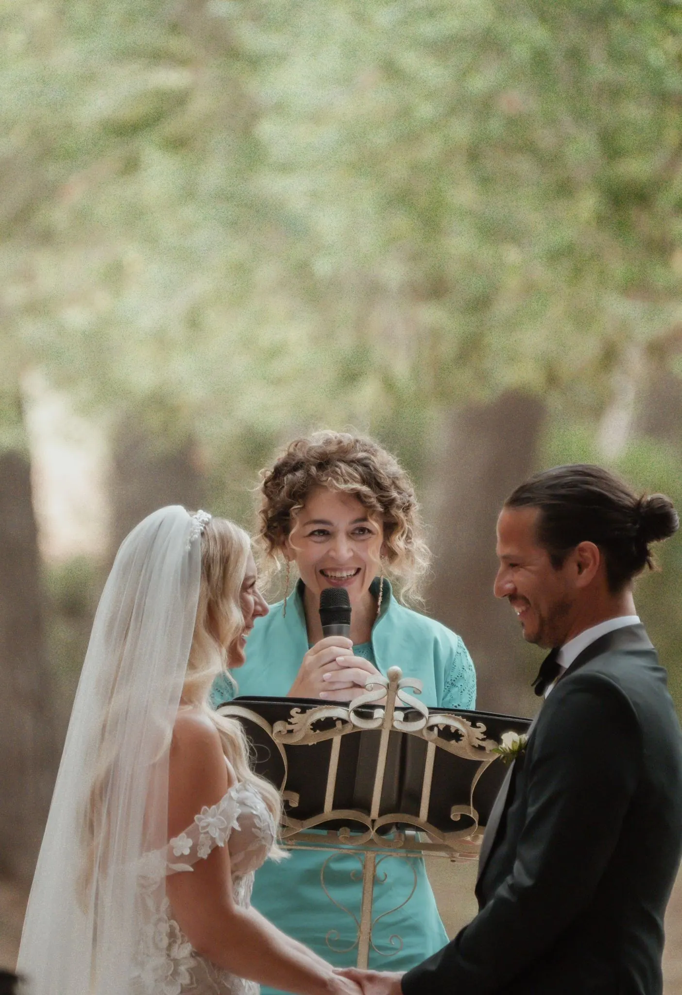 Ximena Paula Barbano with a couple during an outdoor wedding ceremony